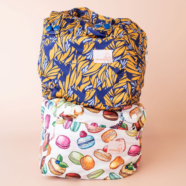Two waterproof pods featuring birds and macarons stacked on top of one another